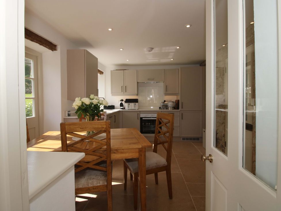 A kitchen with a dining table and chairs at 5 Shrewsbury Road in Much Wenlock