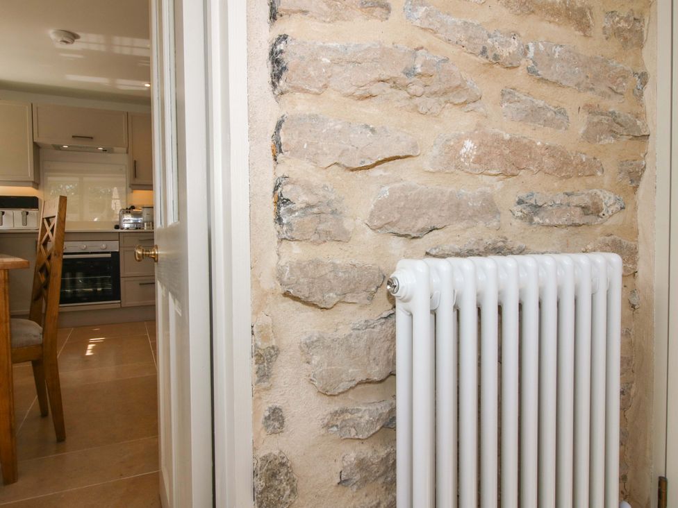 A kitchen with a stone wall and radiator at 5 Shrewsbury Road in Much Wenlock