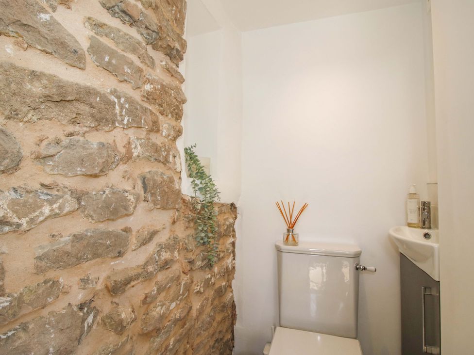 A bathroom featuring a toilet and sink at 5 Shrewsbury Road in Much Wenlock