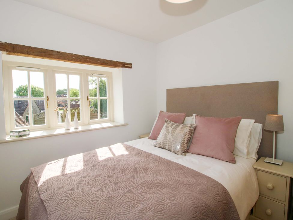A bedroom with a bed and window at 5 Shrewsbury Road in Much Wenlock