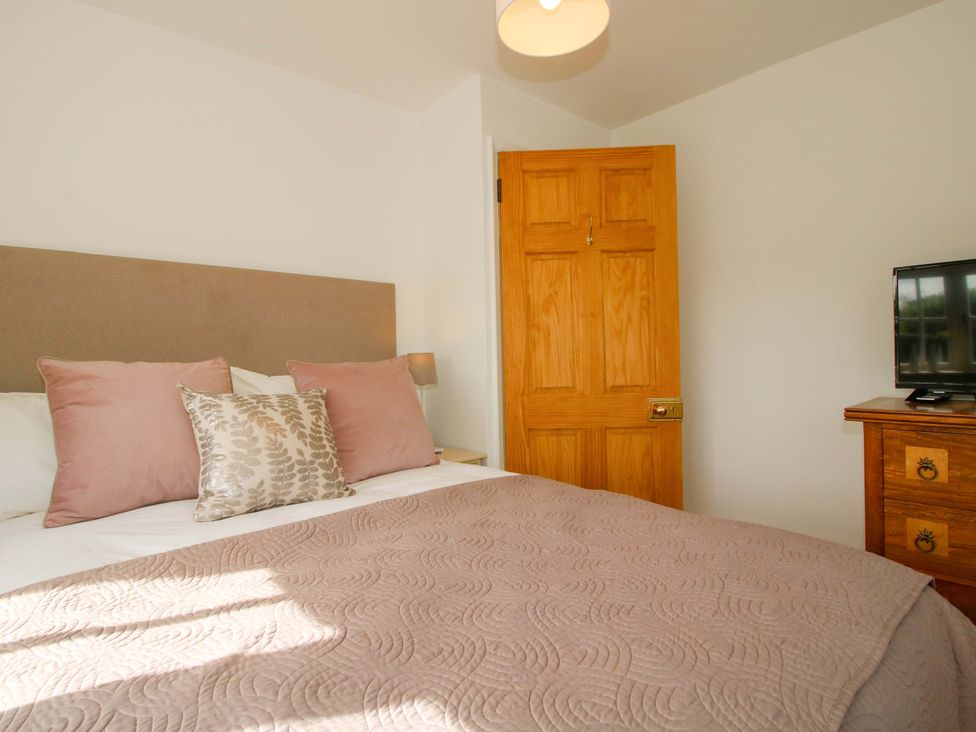 A bedroom with a bed and television at 5 Shrewsbury Road Much Wenlock
