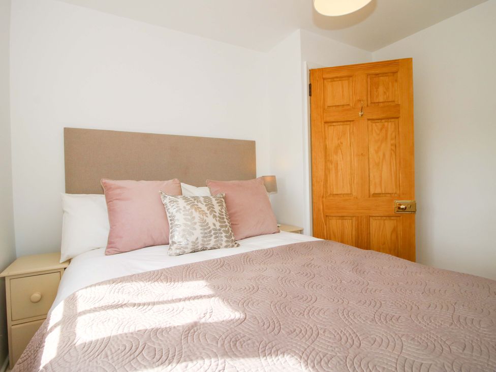 A bedroom with a bed and door at 5 Shrewsbury Road in Much Wenlock