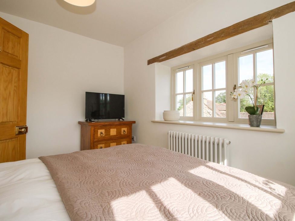 A bedroom with a bed and a television at 5 Shrewsbury Road in Much Wenlock