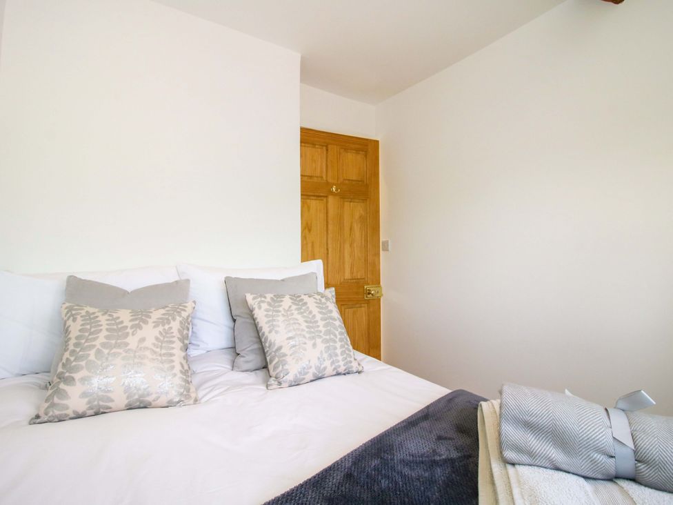 A bedroom with a bed and pillows at 5 Shrewsbury Road in Much Wenlock