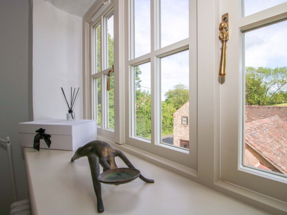 A window view with decor items in an interior space at 5 Shrewsbury Road Much Wenlock