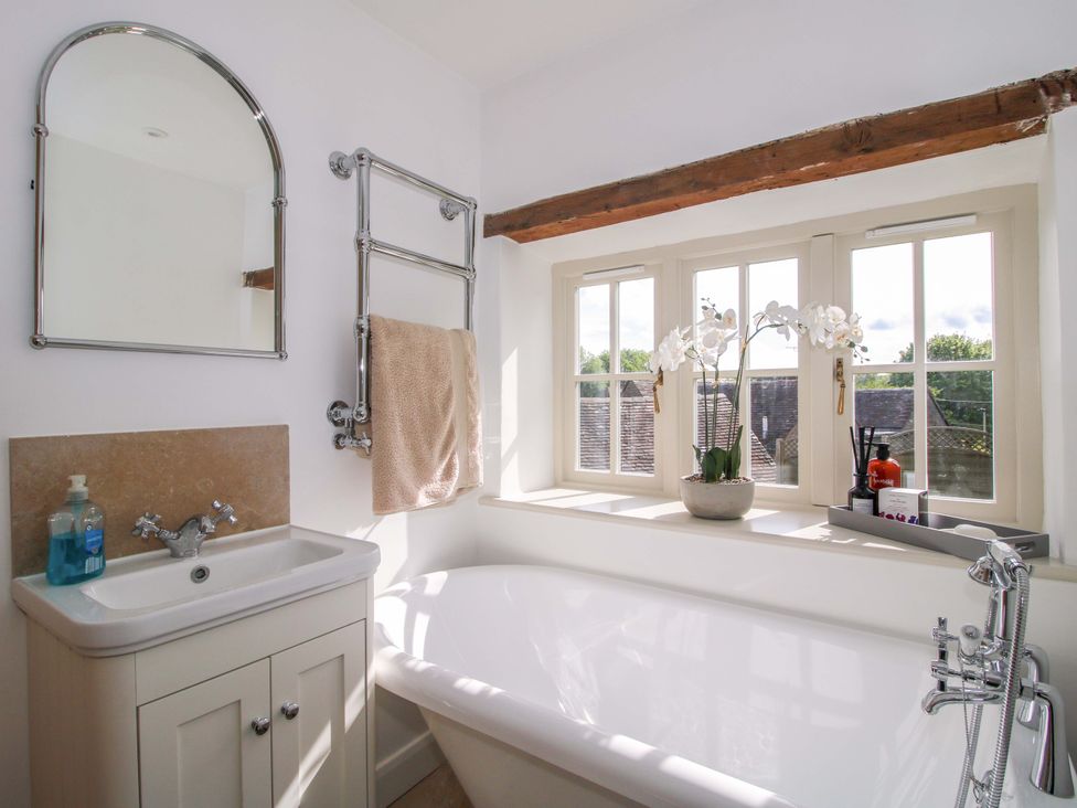 A bathroom with a bathtub and sink at 5 Shrewsbury Road in Much Wenlock