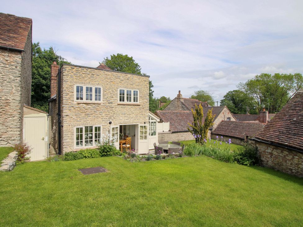 A house with a garden and seating area at 5 Shrewsbury Road in Much Wenlock