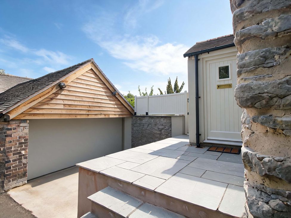 An exterior view of a garage and entrance door at 5 Shrewsbury Road in Much Wenlock