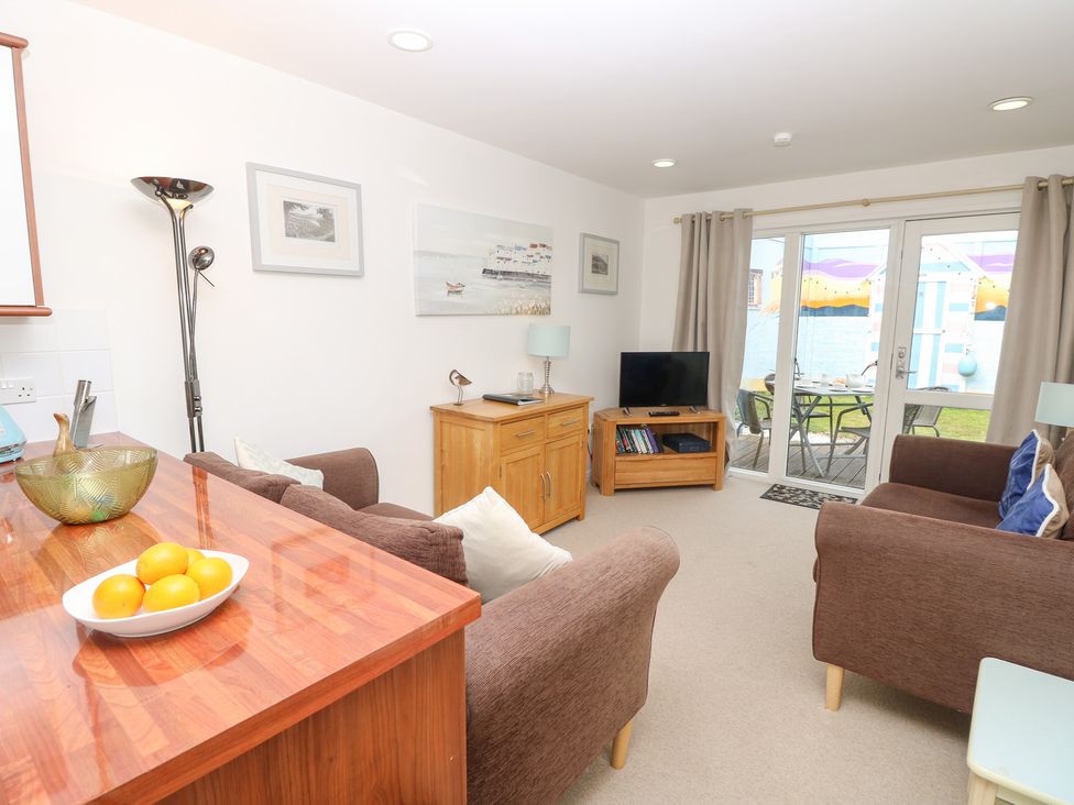 A living room with a sofa and television at Plimoth N8 Yarmouth