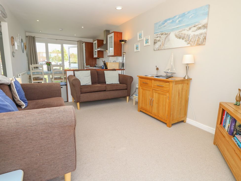 A living room with a sofa and armchair at Plimoth N8 in Yarmouth