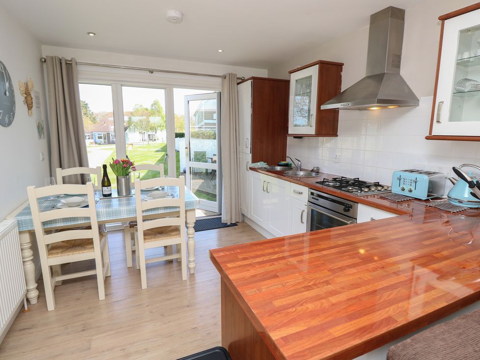 A kitchen with table and chairs at Plimoth N8 in Yarmouth