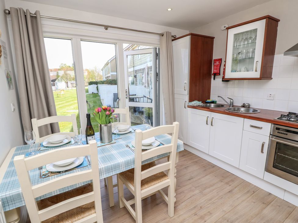 A kitchen with a dining table and view of the outdoor area at Plimoth N8 Yarmouth