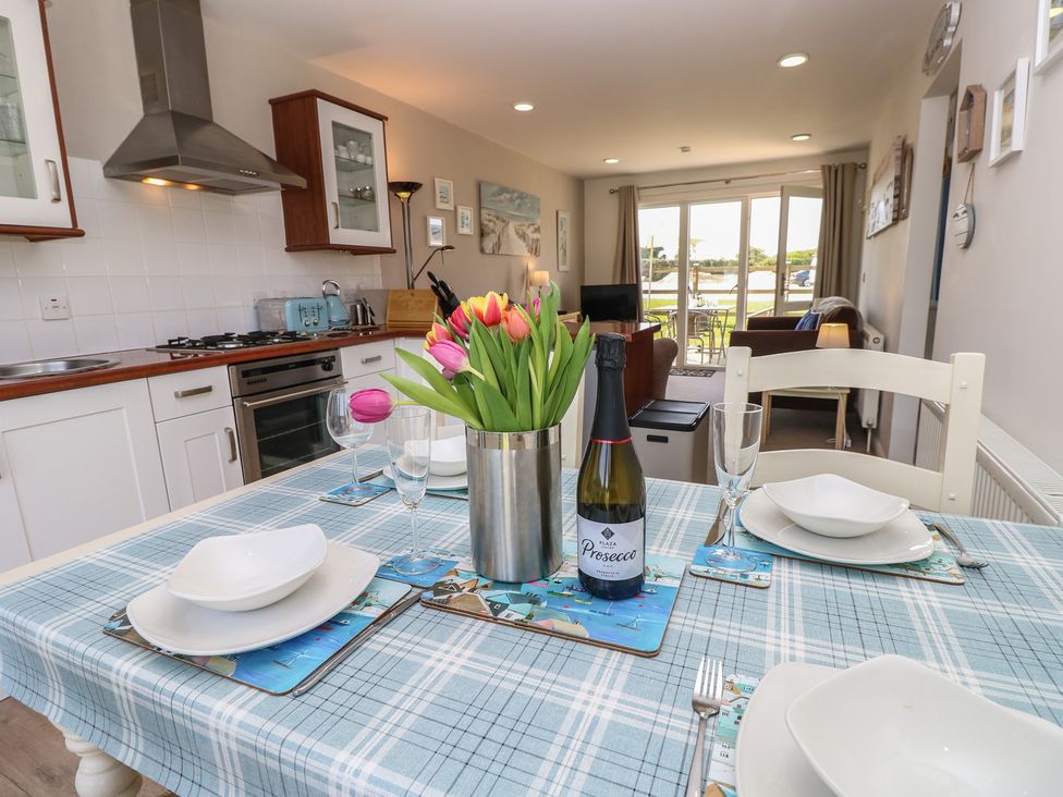 A kitchen with a dining table set at Plimoth N8 Yarmouth