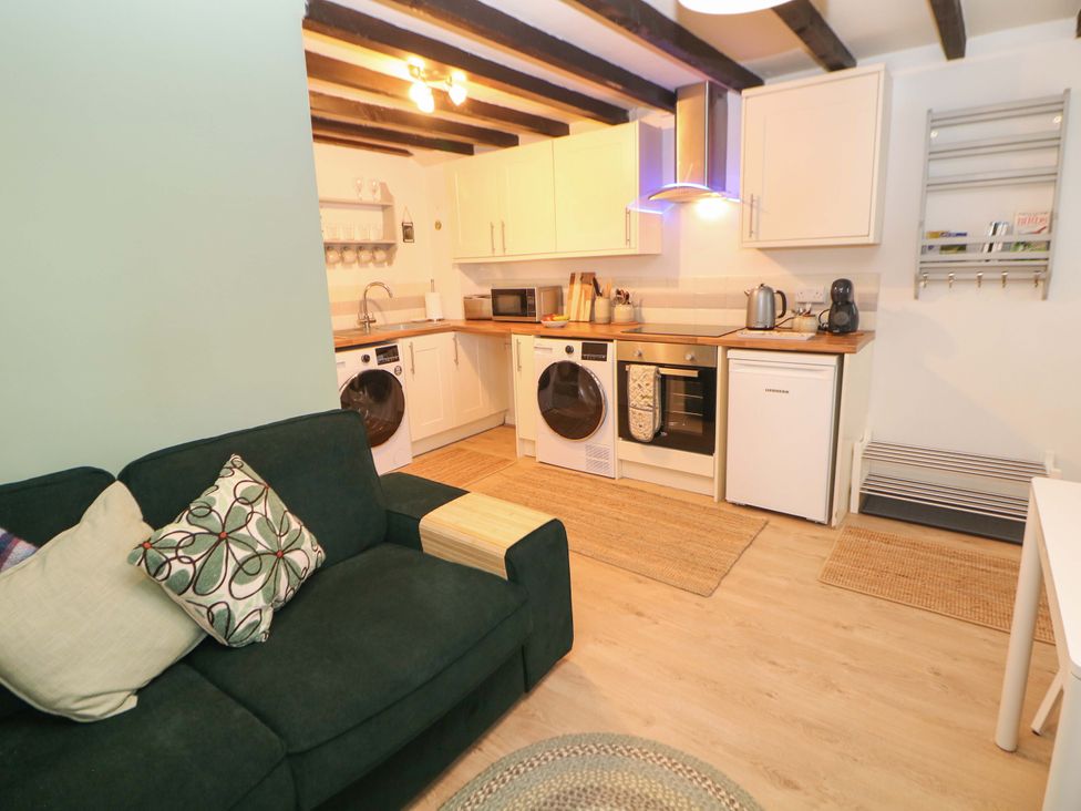A kitchen with a sofa and appliances at Little Thornsett