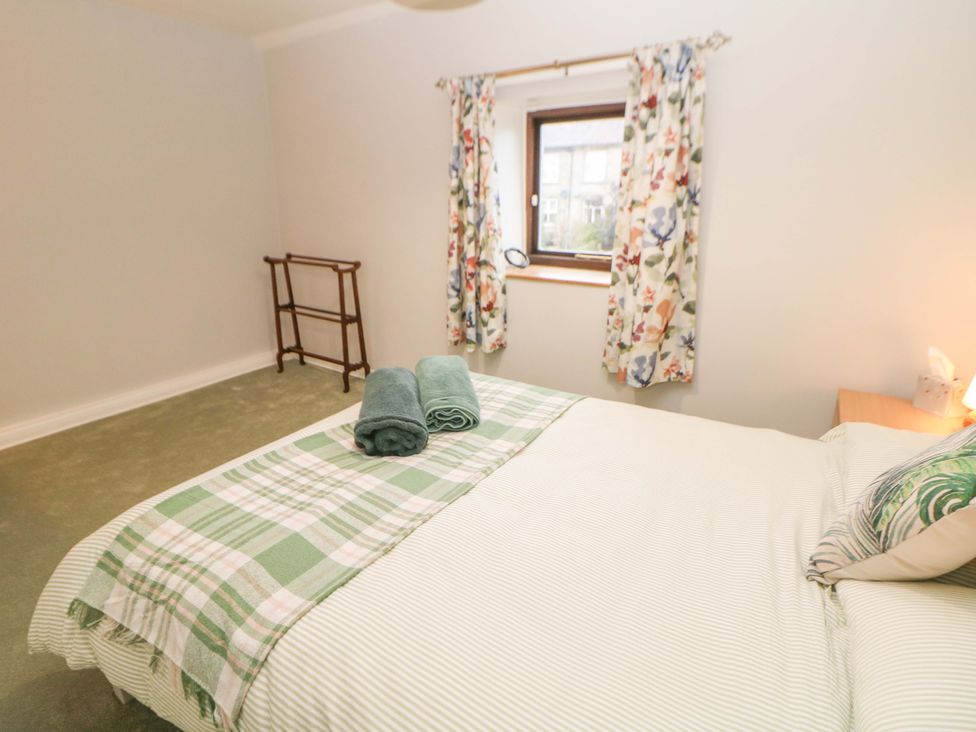 A bedroom with a bed and towels on it at Little Thornsett