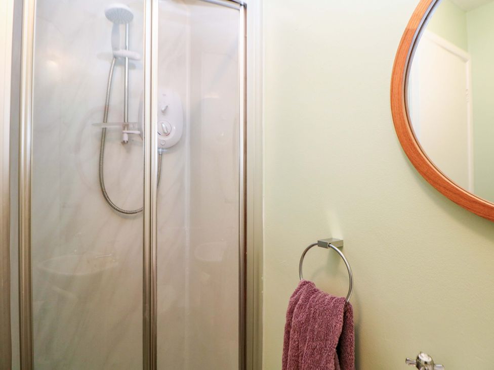 A bathroom with a shower and a towel on the rack at Little Thornsett