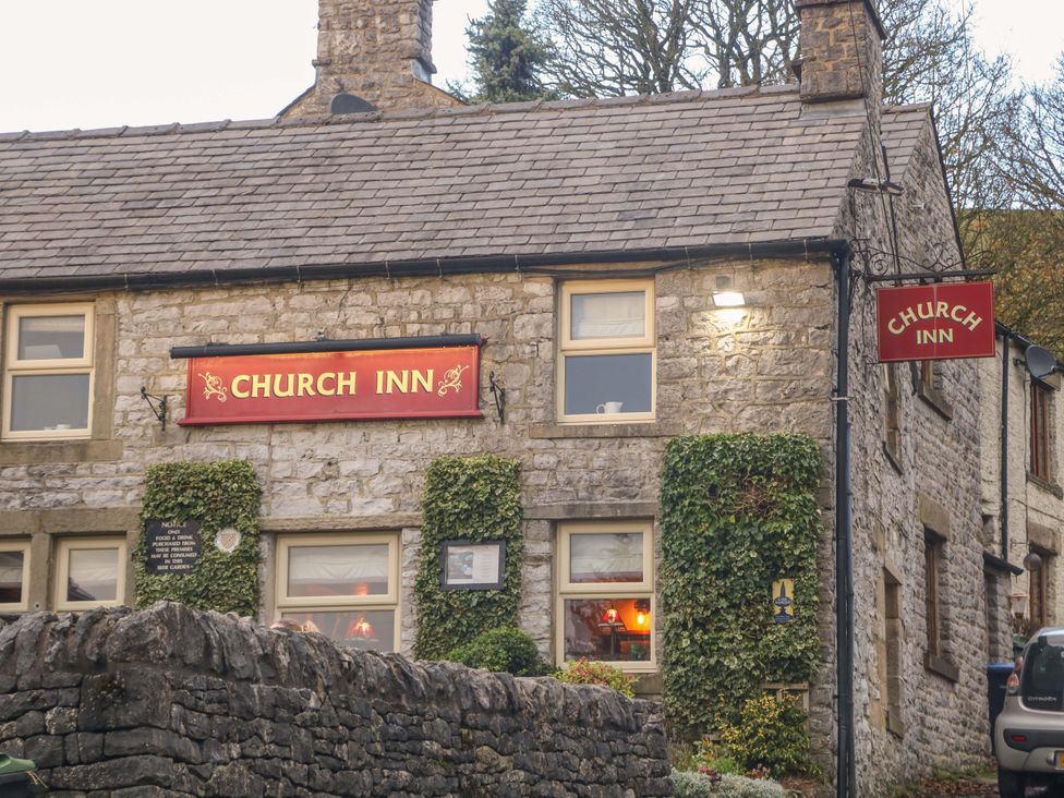 An exterior view of Church Inn with ivy on the wall at Little Thornsett