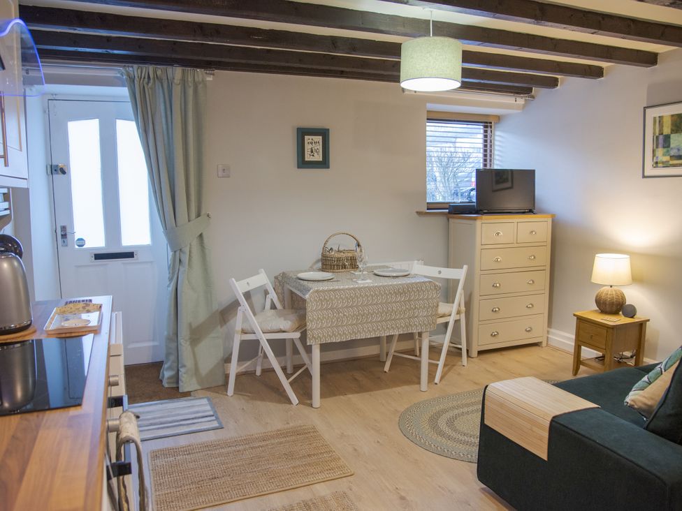 A living room with a table and chairs at Little Thornsett in Chelmorton