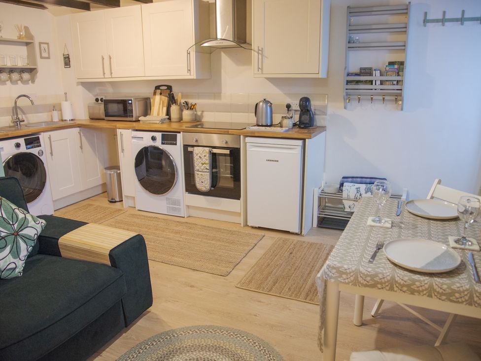 A kitchen with appliances and a dining area at Little Thornsett in Chelmorton