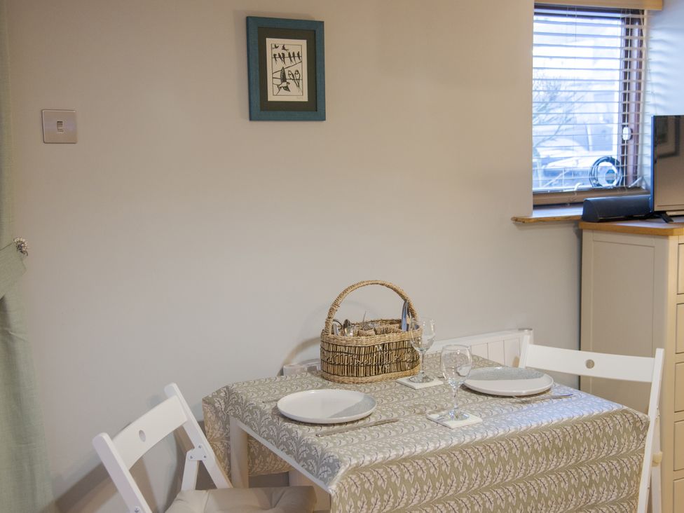 A dining room with a table and chairs at Little Thornsett in Chelmorton