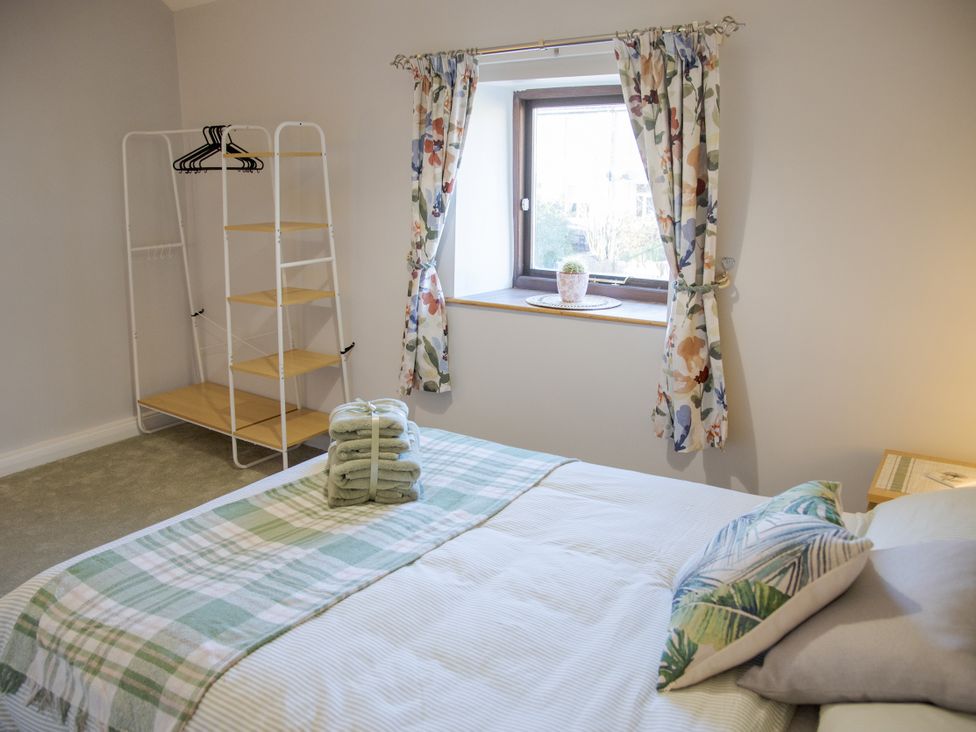 A bedroom with a bed and shelving unit at Little Thornsett in Chelmorton