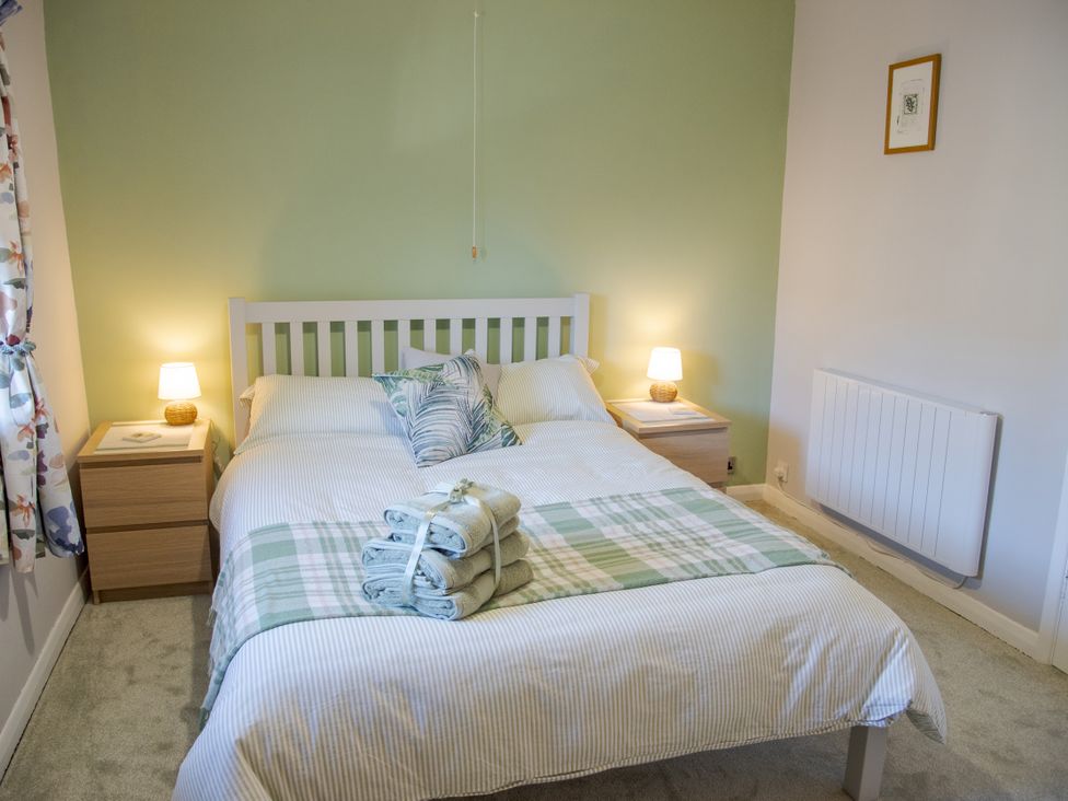 A bedroom with a bed and bedside table at Little Thornsett in Chelmorton