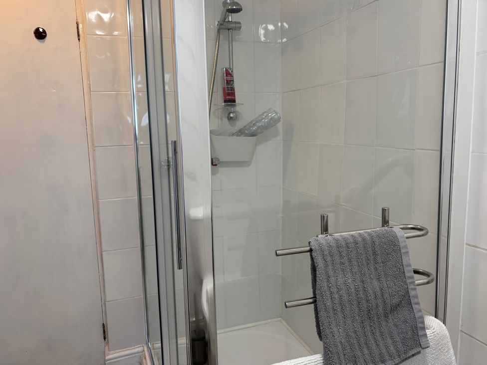 A shower with a towel on the rack at Coedmor Newport, Pembrokeshire