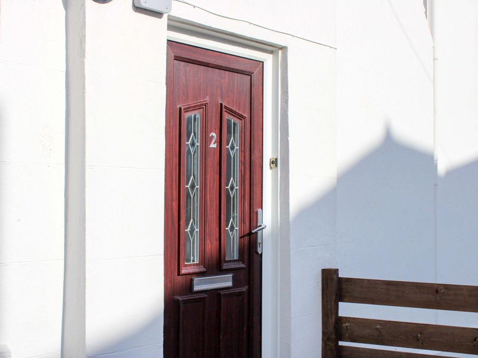 A door with number 2 at the entrance of 2 The Elms in Salcombe