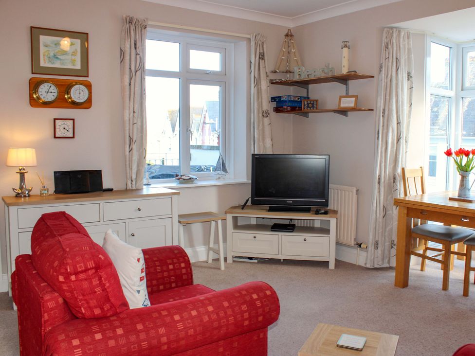 A living room with a television and seating area at 2 The Elms Salcombe