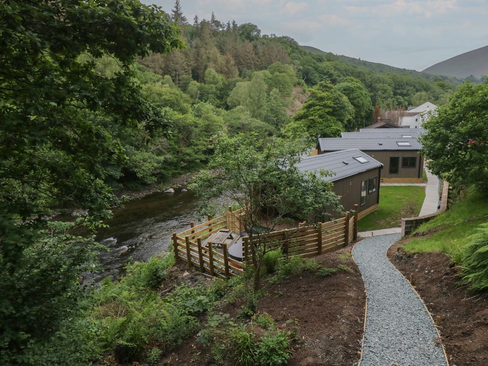 A view of a river along with buildings and trees at Dubs Luxury Family Pod in Keswick