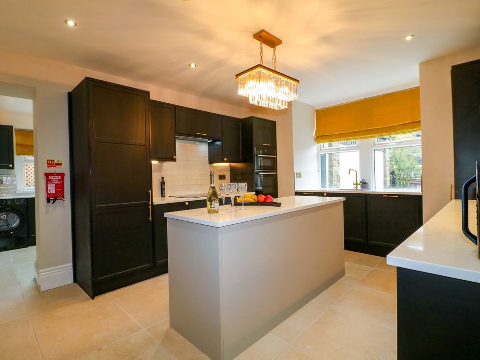 A kitchen with an island and appliances at High Peaks Villa in Buxton