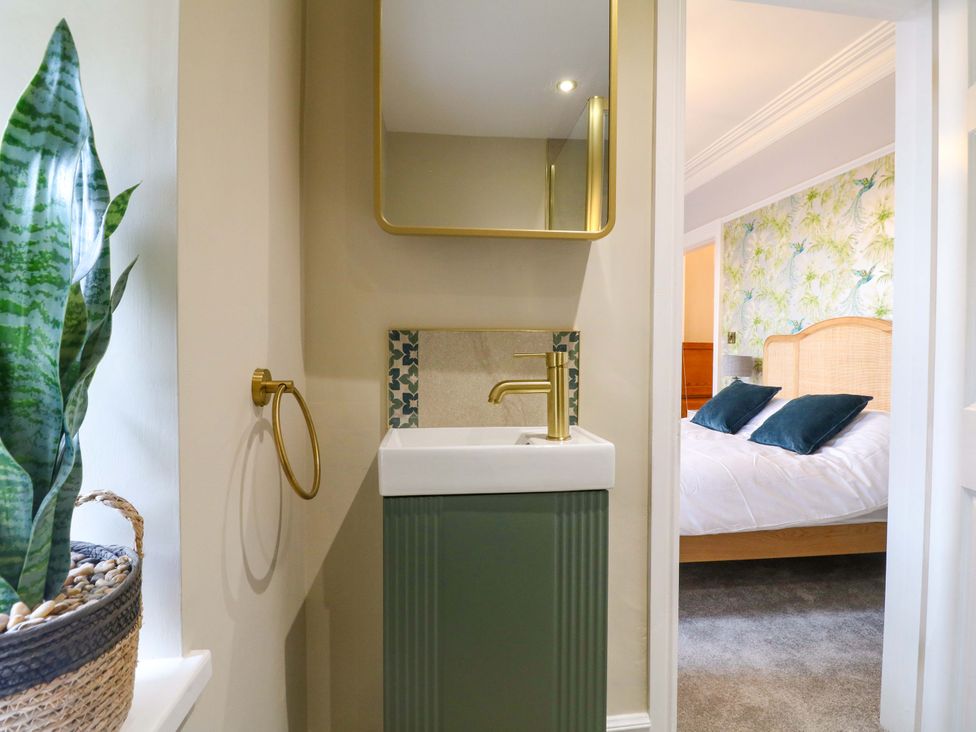 A bathroom with a sink and mirror at High Peaks Villa in Buxton