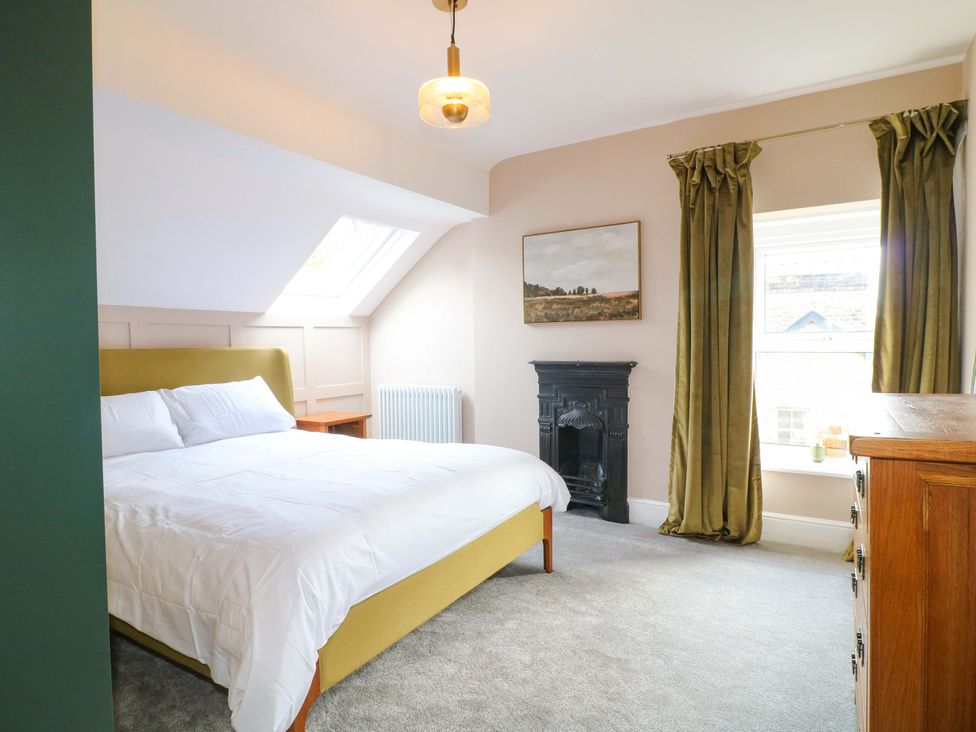 A bedroom with a bed and chest of drawers at High Peaks Villa in Buxton