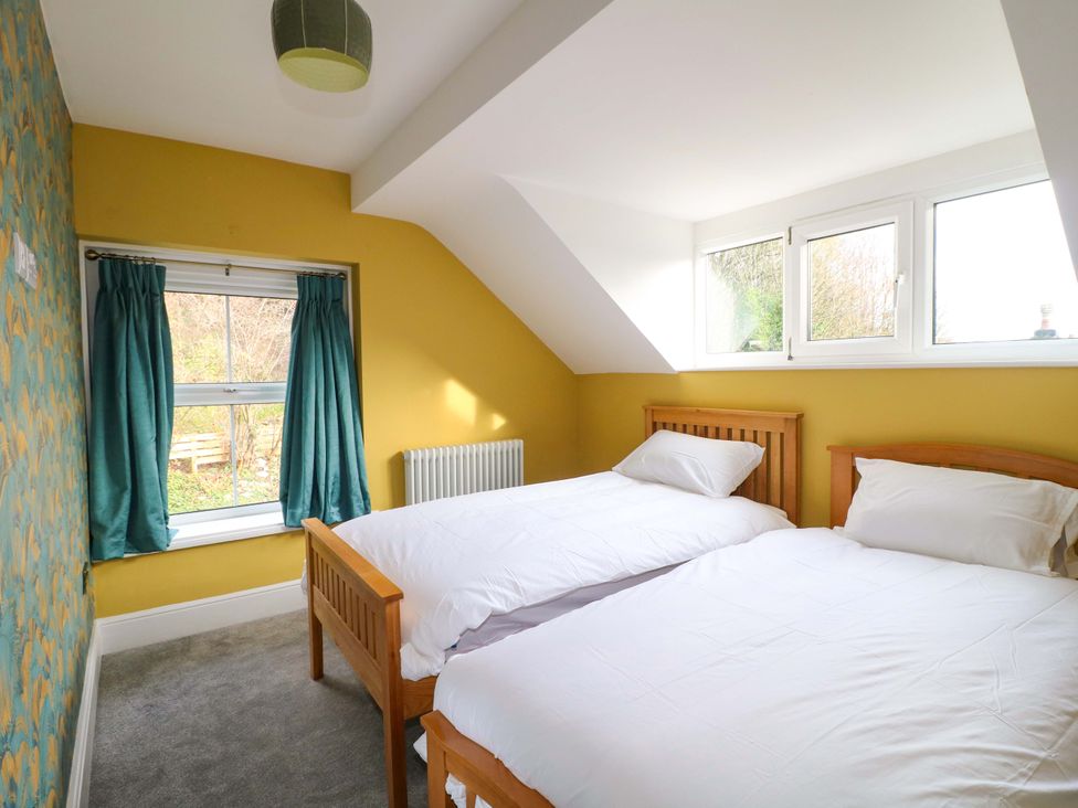 A bedroom with two beds and a window at High Peaks Villa in Buxton