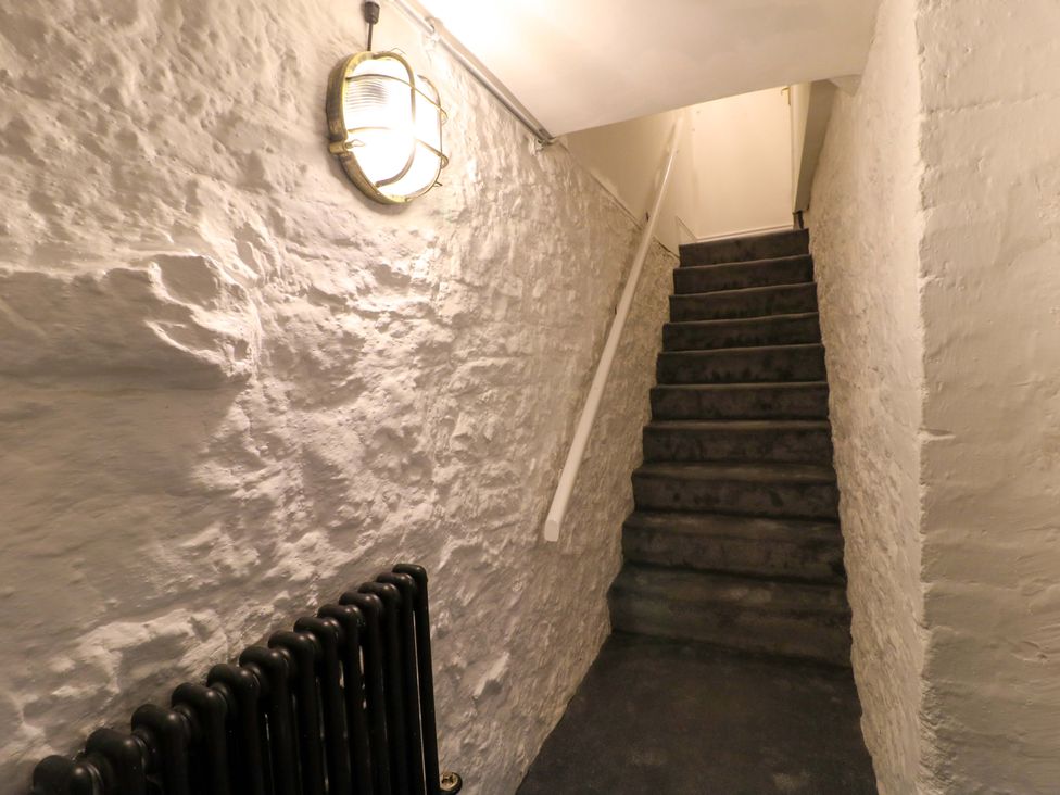 A staircase with a light fixture and radiator at High Peaks Villa in Buxton