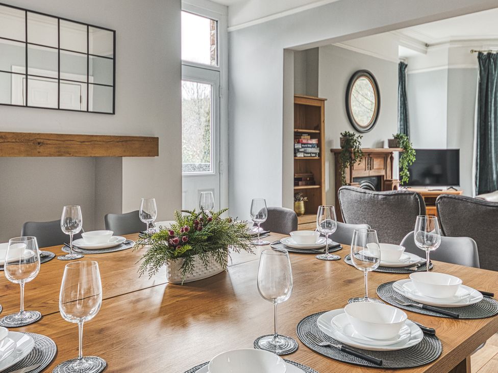 A dining room with a table set for meals at High Peaks Villa in Buxton