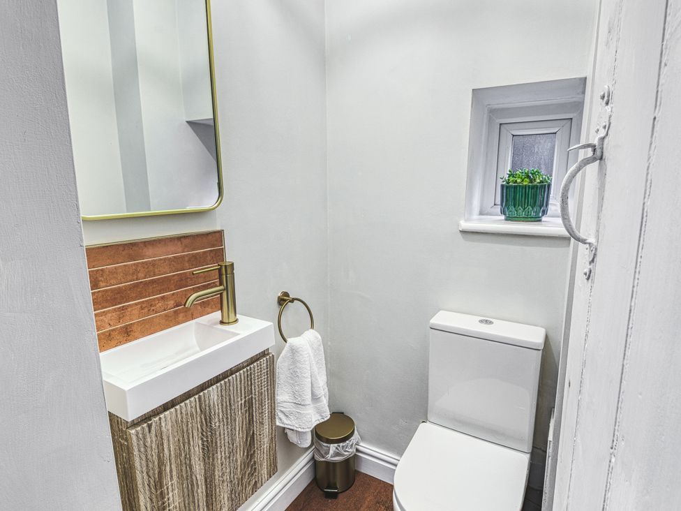 A bathroom with a toilet and sink at High Peaks Villa in Buxton
