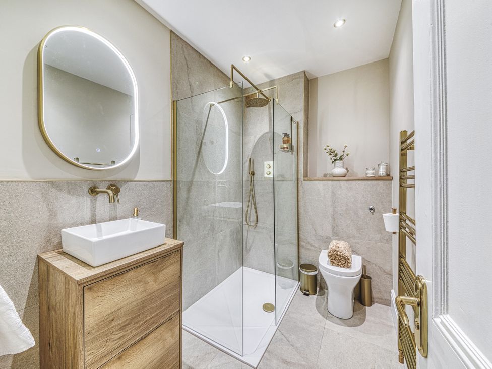 A bathroom with a glass shower and wash basin at High Peaks Villa in Buxton