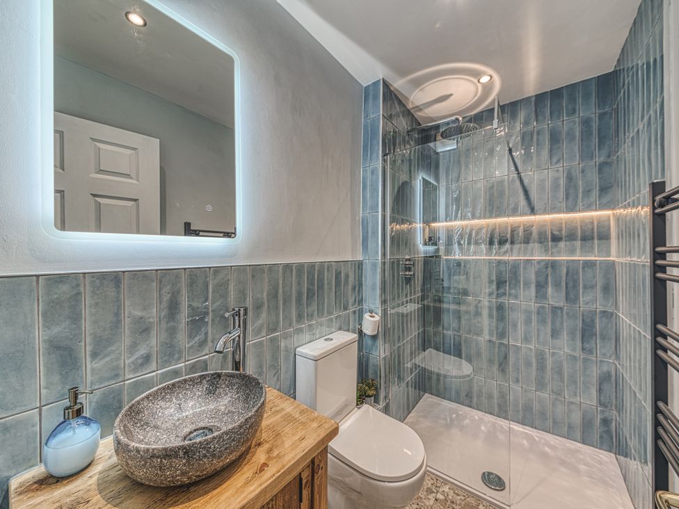 A bathroom with a shower, toilet, and wash basin at High Peaks Villa Buxton
