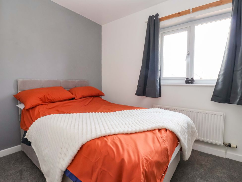 A bedroom with a bed and window at 8 Wharfedale Mews Otley