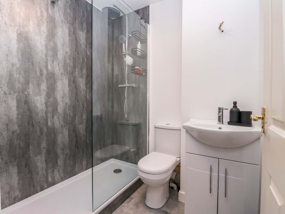 A bathroom with a shower, toilet, and sink at 8 Wharfedale Mews, Otley