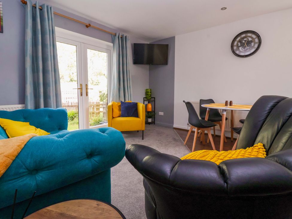 A living room with a sofa and armchair at 8 Wharfedale Mews Otley