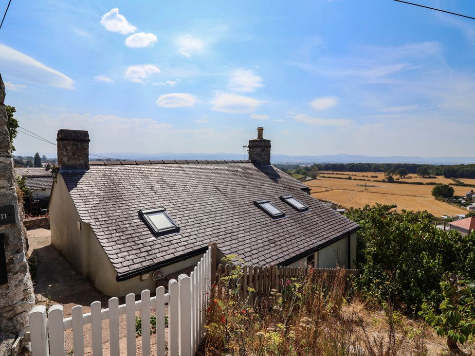 A house with a sloped roof and skylights overlooking fields at Ael Y Bryn in Dyserth