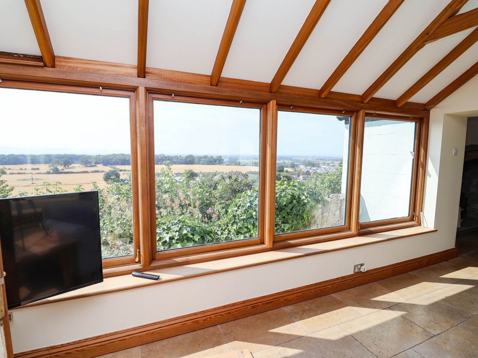 A conservatory with a view of the countryside at Ael Y Bryn in Dyserth