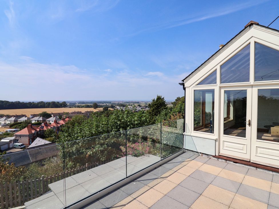 A balcony with glass railings and a view at Ael Y Bryn Dyserth