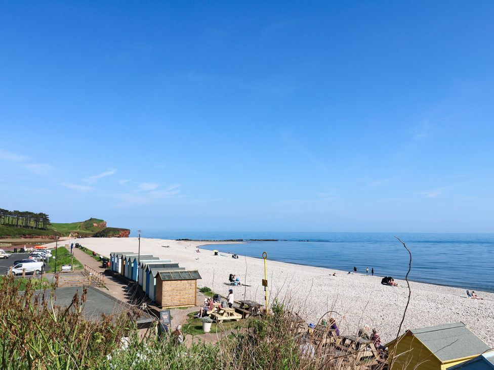 A beach with huts and people at Badger's Den Budleigh Salterton