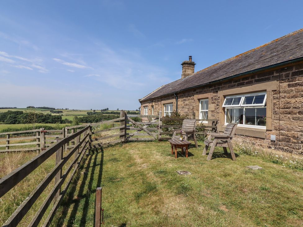 A wooden house with chairs and a table in the garden at Folly View Eglingham