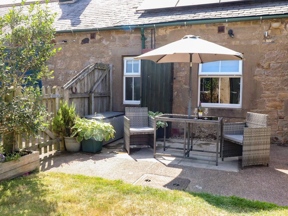 An outdoor seating area with a table and chairs at Folly View in Eglingham
