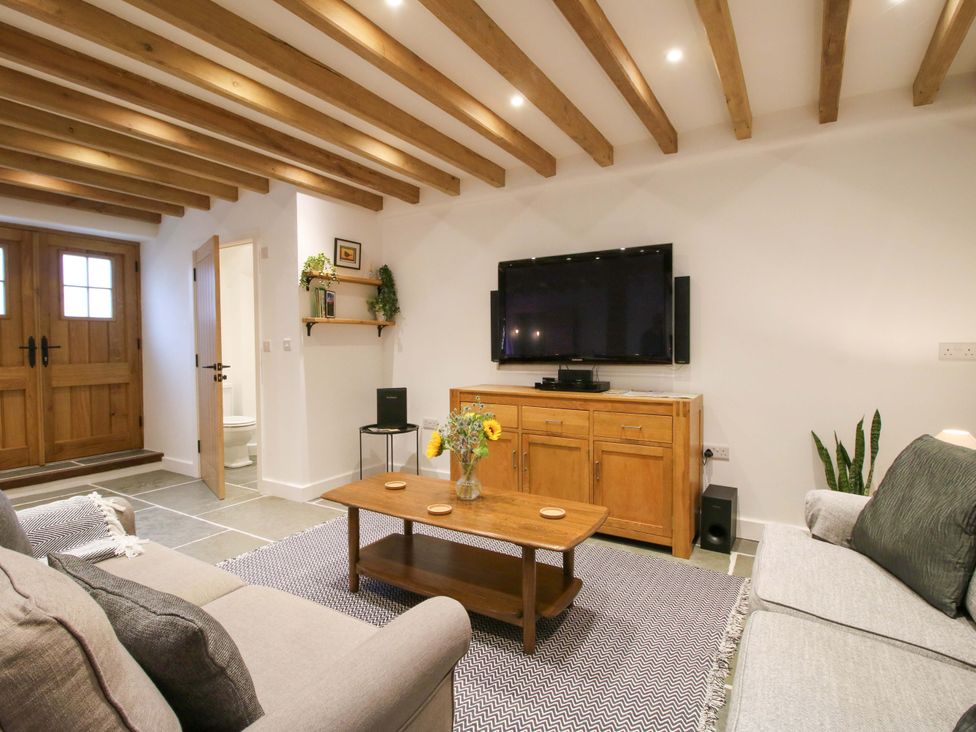A living room with a sofa and television at The Hideaway in Bishop's Castle