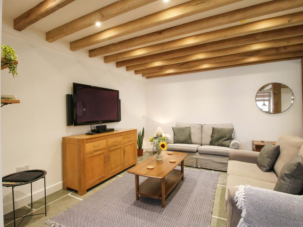 A living room with a sofa and coffee table at The Hideaway in Bishop's Castle